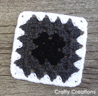 Black gray and white granny square with a light outer round